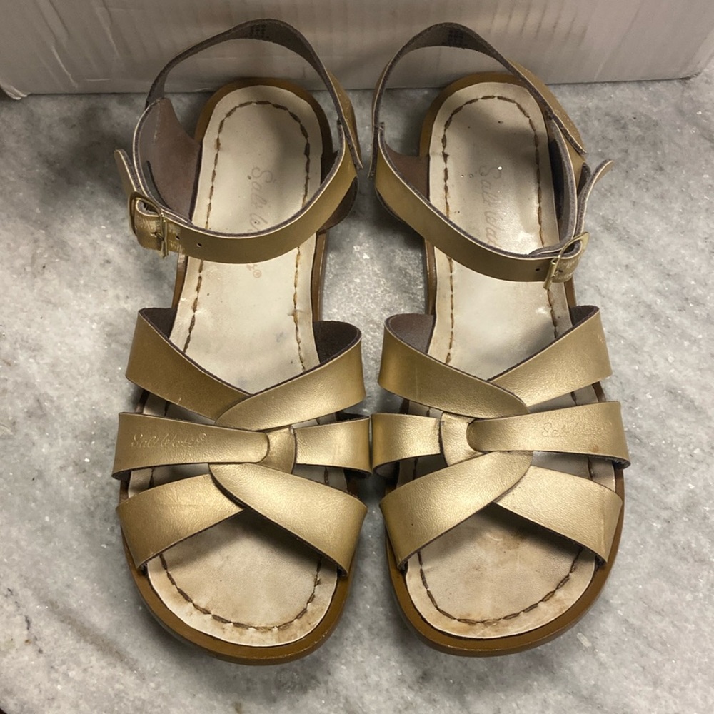Used gold salt water sandles a little worn out but still cute and colorful.